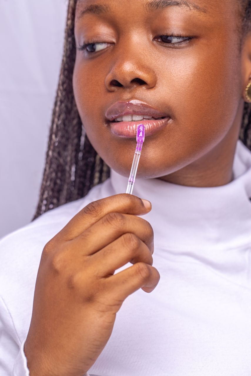 Woman applying Esthetical lip gloss